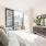 Modern furnished apartment bedroom with floor to ceiling windoes at Signal House